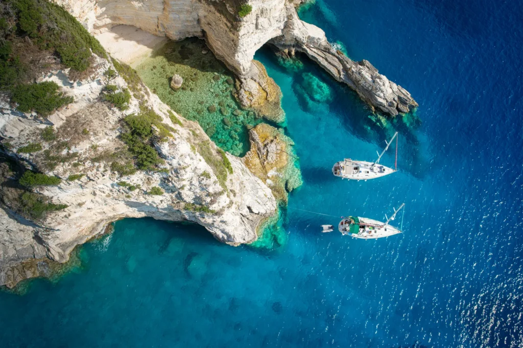 Sailboats by the sea caves of Paxos