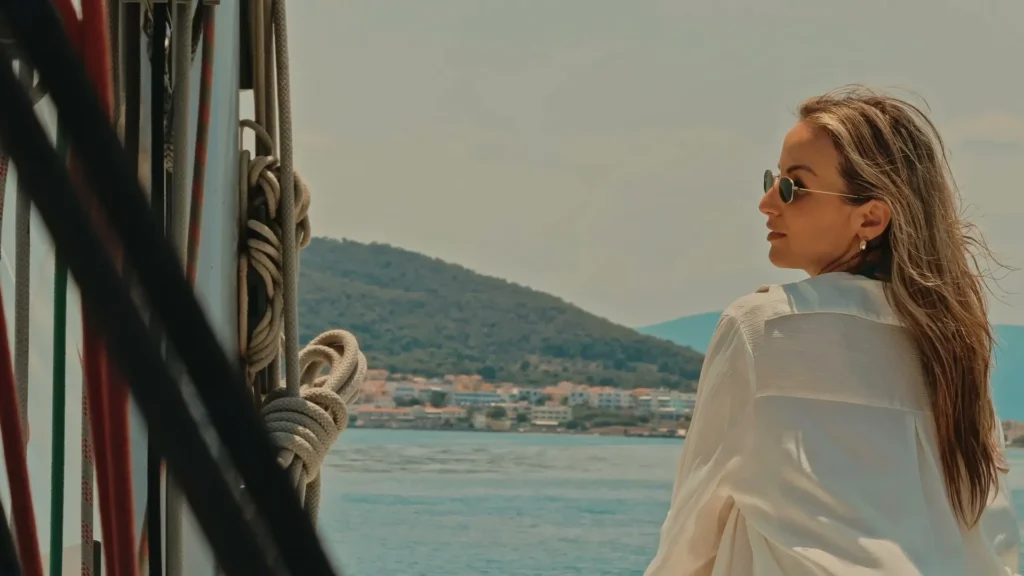 Couple relaxing on the bow of a sailing yacht