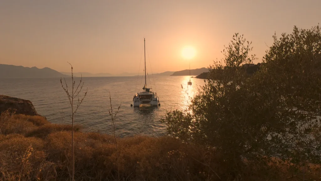 Sailing yacht at anchor at sunset in a quiet Saronic bay