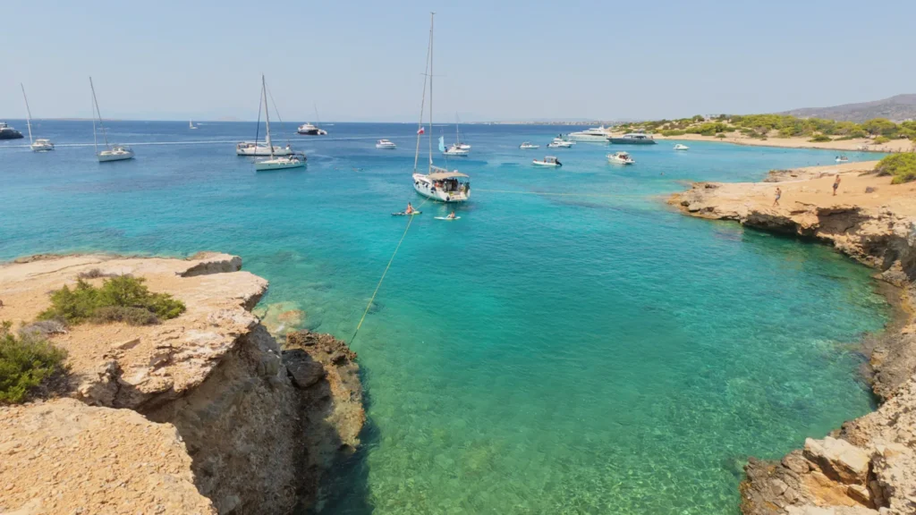 Yachts anchored in a turquoise bay in the Saronic Gulf