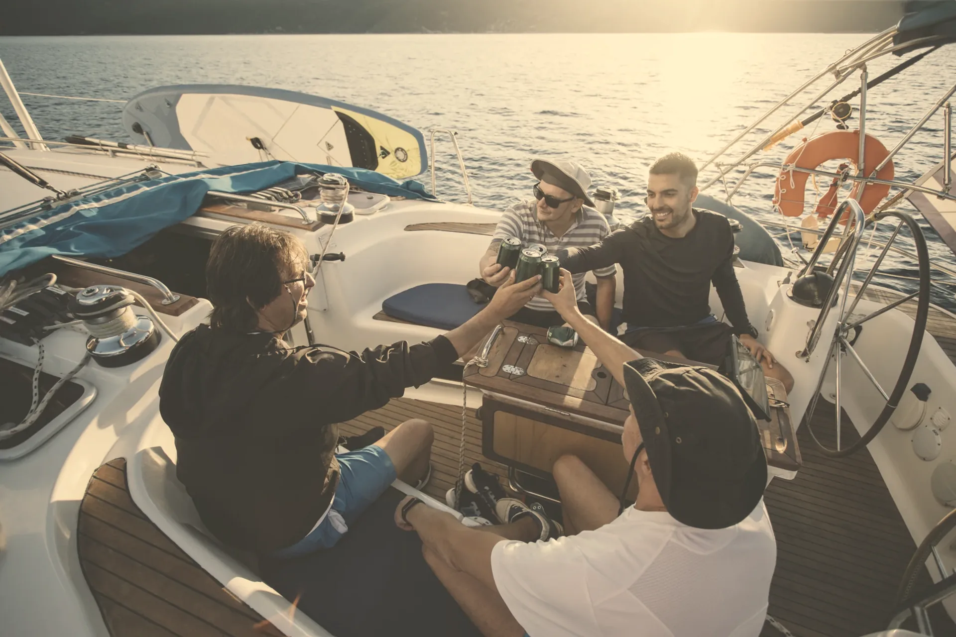Friends at the helm of a sailboat in Greece