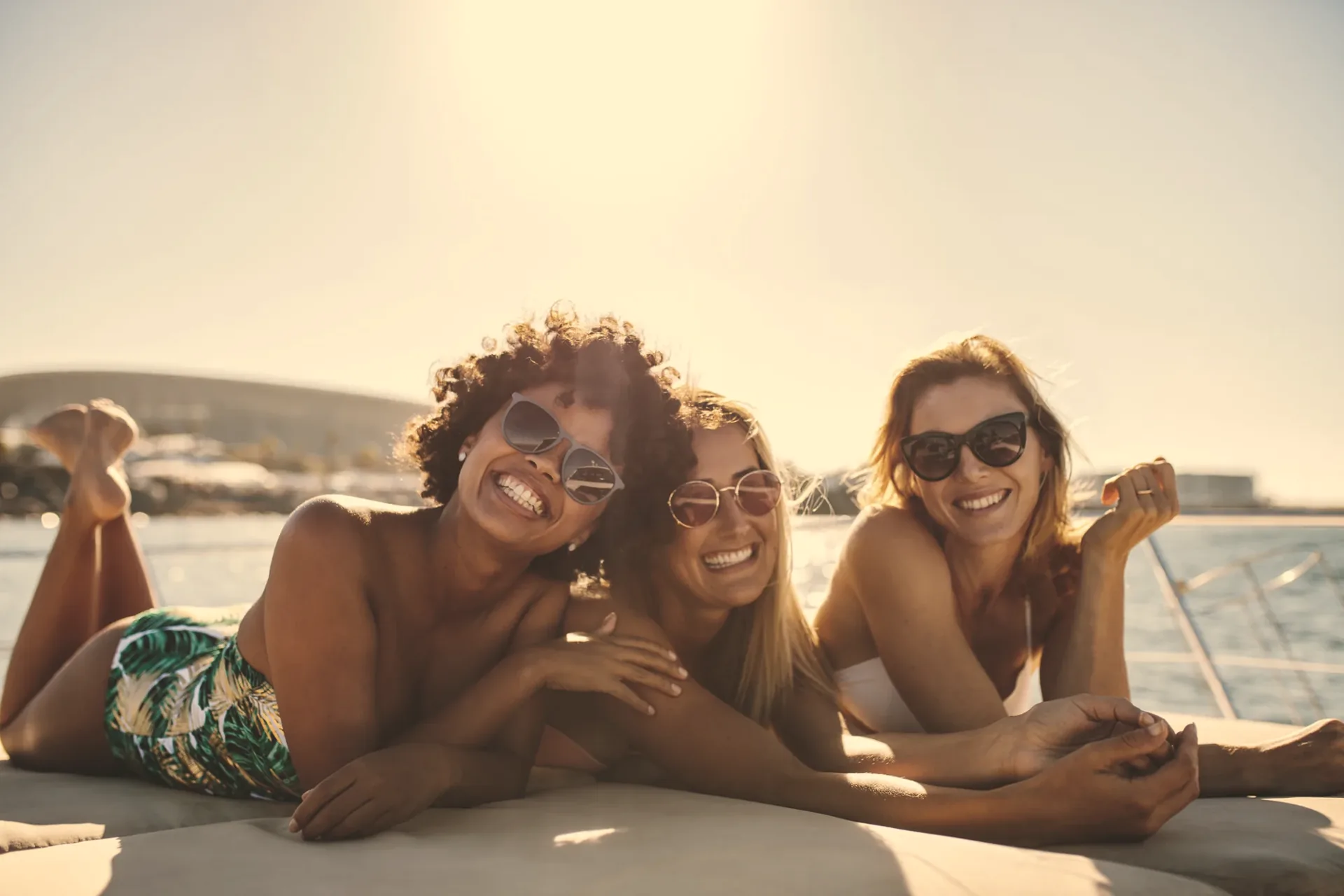 Friends relaxing on a yacht deck in the sun