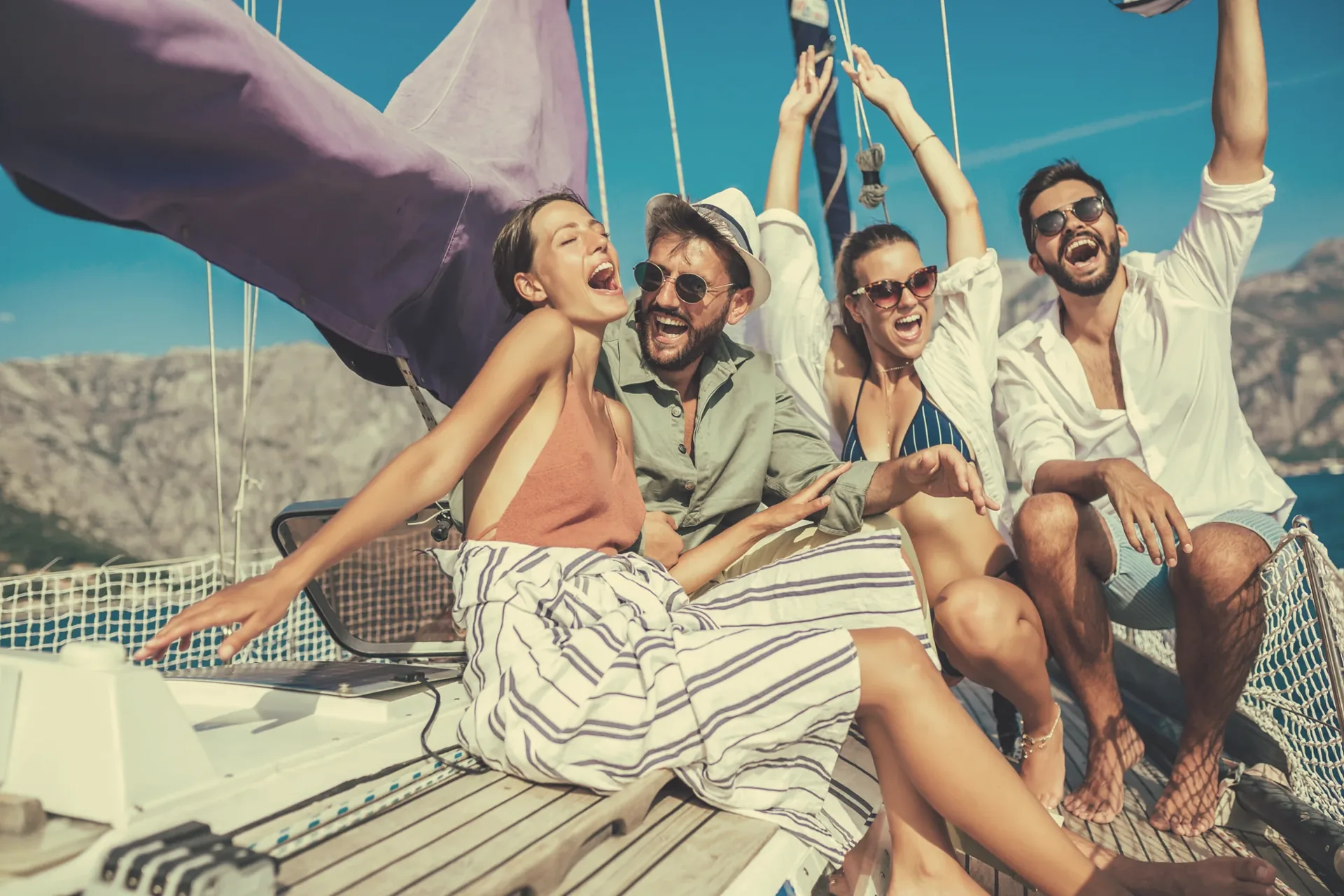 Friends laughing together on a sailing holiday in Greece