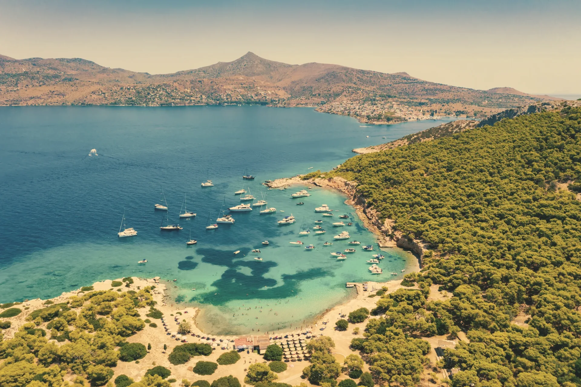 Aerial view of a bay with anchored yachts at Moni island, Saronic Gulf
