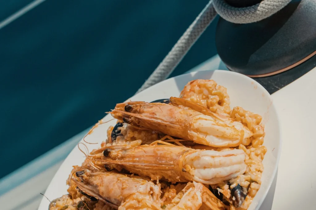 Shrimp pasta served on the deck of a sailing yacht