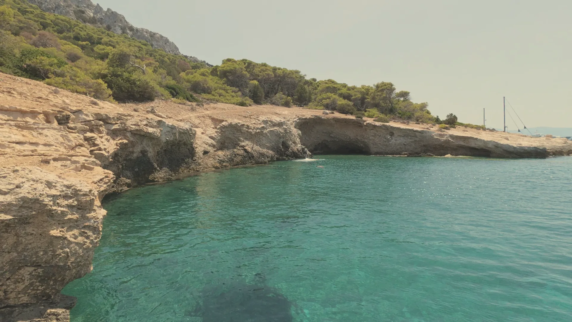 Rocky cove with turquoise water in the Saronic Gulf